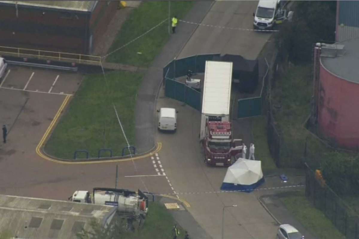 An aerial view as police forensic officers attend the scene after a truck was found to contain a large number of dead bodies, in Thurock, South England, early Wednesday Oct. 23, 2019. Police in southeastern England said that 39 people were found dead Wednesday inside a truck container believed to have come from Bulgaria. (UK Pool via AP)